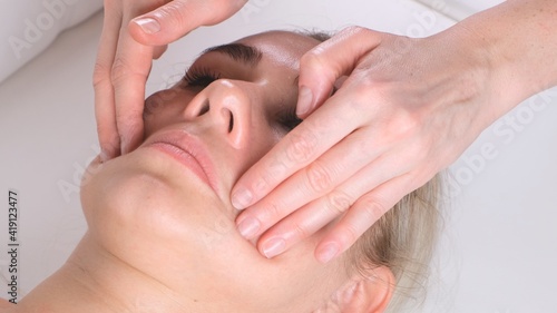 Beautiful girl has a facial massage in a beauty clinic. concept skin care  spa concept  treatment  facial massage