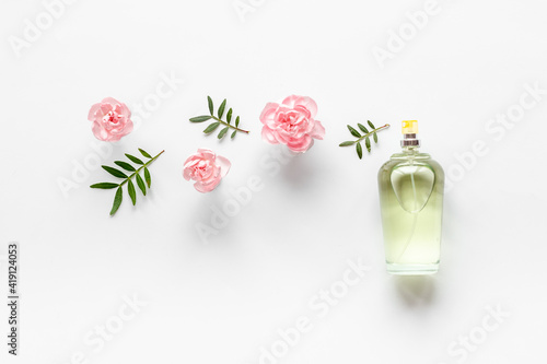 Transparent perfume with flowers and leaves. Flat lay, overhead view