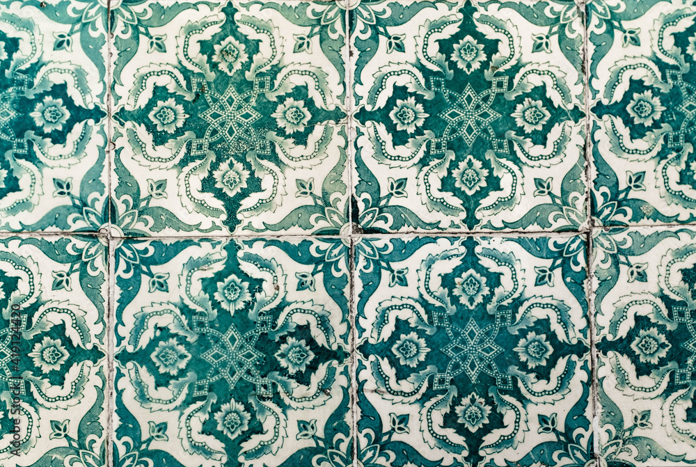 Portuguese traditional tiles Azulejos with green floral pattern on a white background.