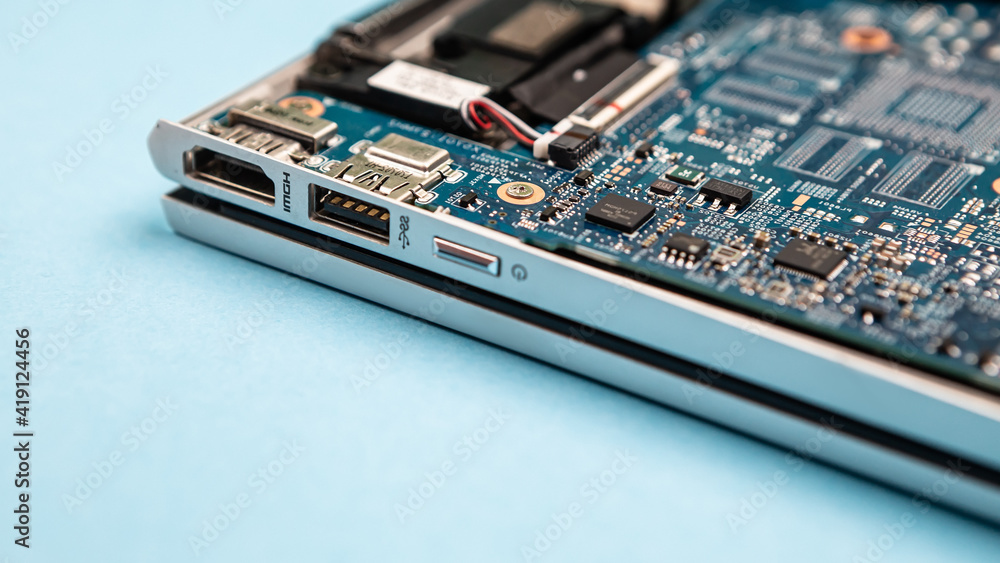 Obraz premium Close up laptop without cover inside disassembling in repair shop. Computer service engineer technician workplace repairing fixing broken components upgrade system, microelectronics copy space