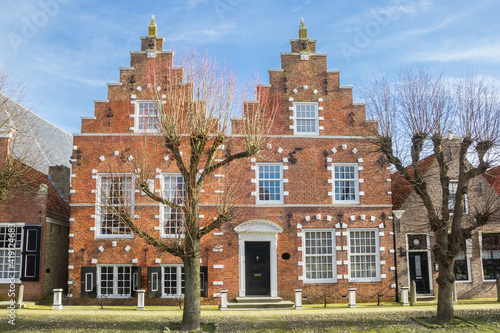 Front facade with step gables on historic houses in Sloten, Netherlands photo