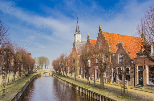 Central canal with the protestant church and old houses in Sloten, Netherlands