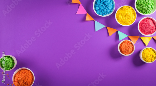 Happy holi festival decoration.Top view of colorful holi powder on purple  background with copy space for text.
