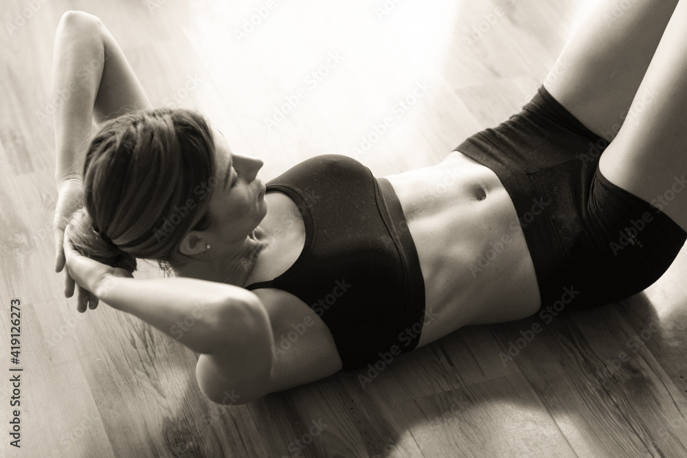 Fototapeta premium Slim woman during home workout.
