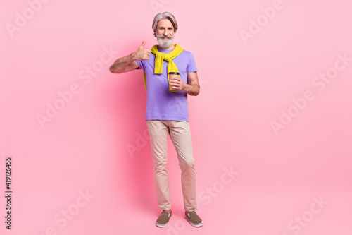 Photo of mature man happy drink coffee show thumb-up like cool ad advice sweater on shoulders isolated over pink color background