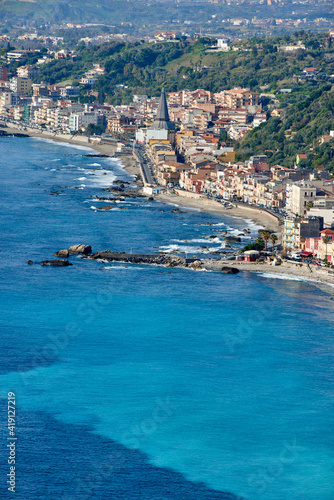 The coast of Eastern Sicily with the city of Giardini Naxos, an ancient Greek colony