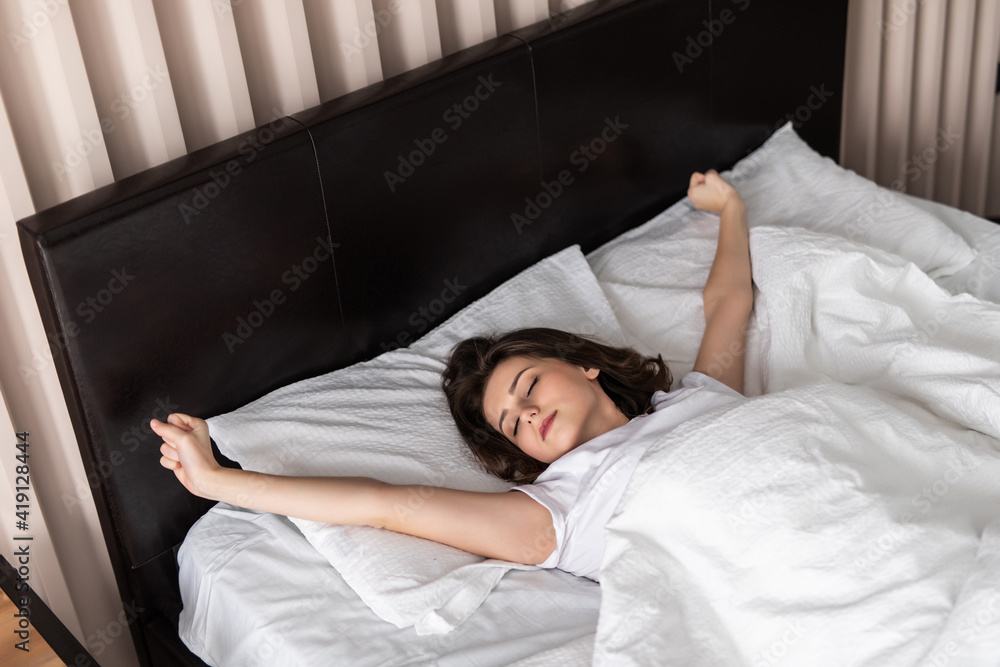 Young beautiful woman waking in the morning up fully rested.