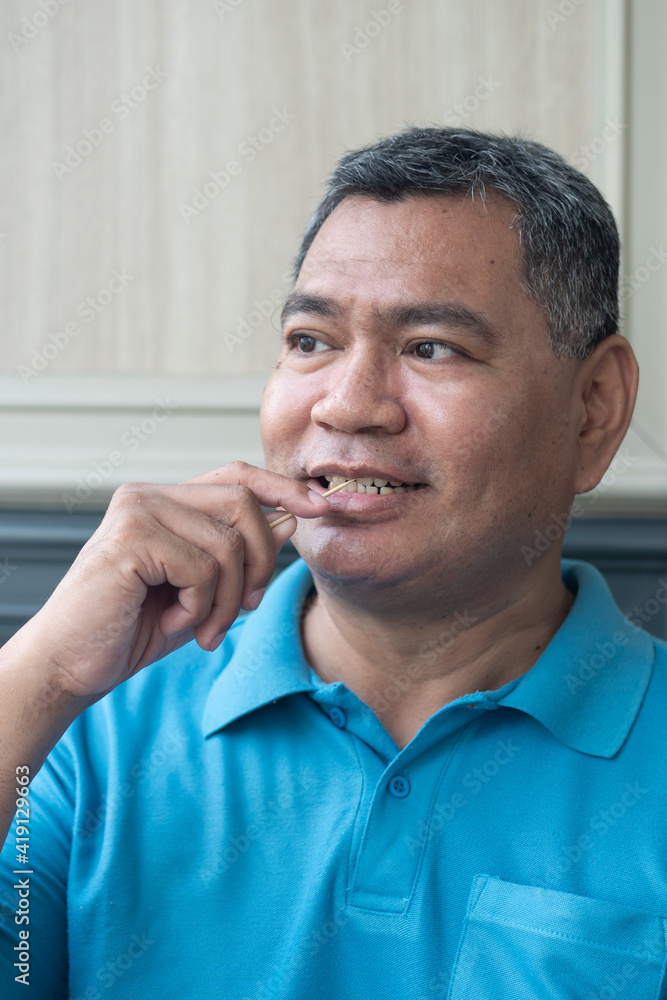 Photo & Art Print man with crooked teeth using toothpick, concept 