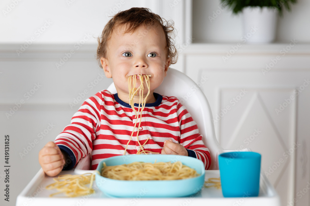 Funny baby eating a mouthful of spaghetti noodles Funny baby eating a mouthful of spaghetti noodles