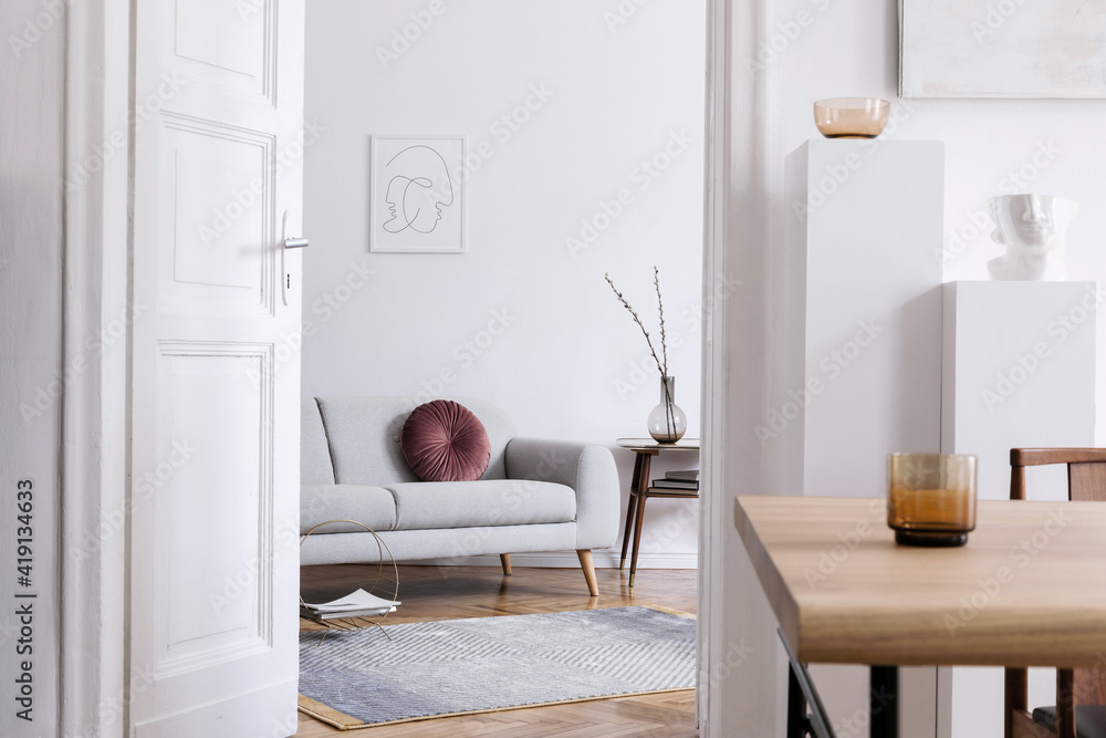 Stylish scandi interior of home space with design grey sofa, retro ...