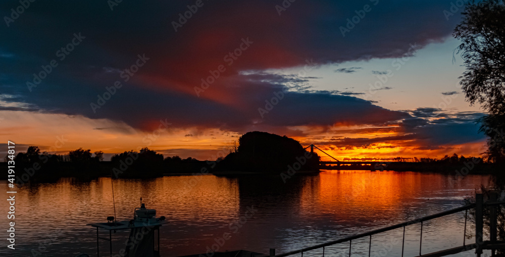 Beautiful sunset with reflections and a dramatic sky near Metten, Danube, Bavaria, Germany