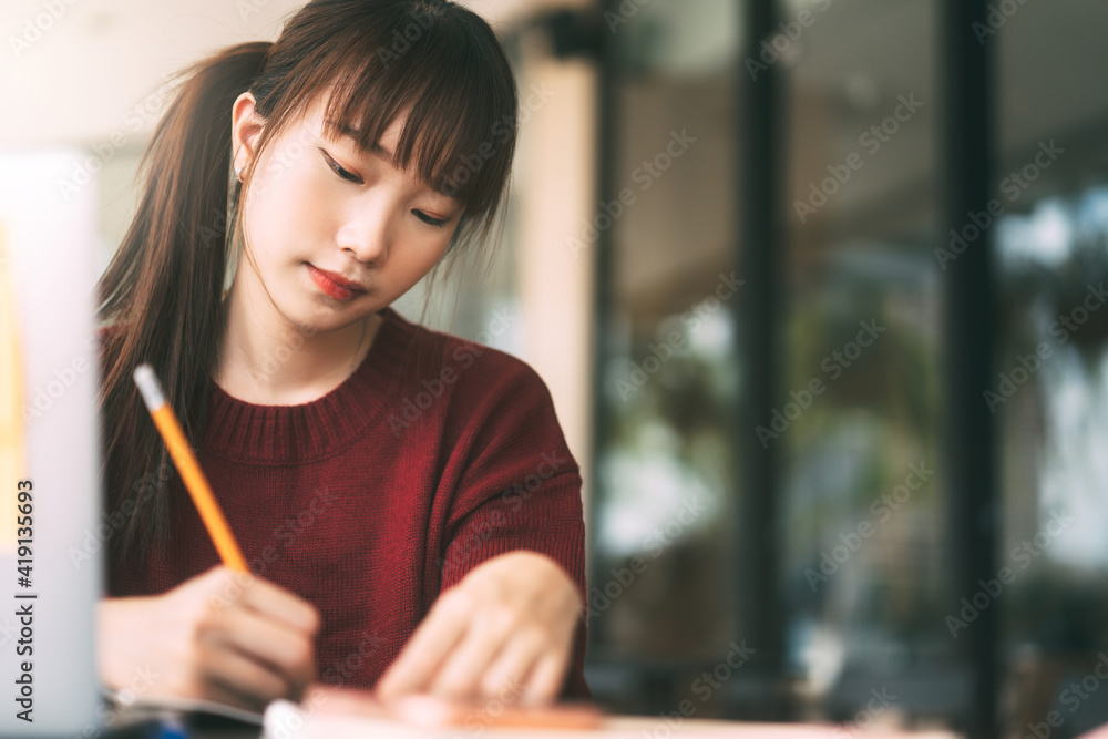 Young adult asian college student woman with laptop for study at cafe on winter day. Young adult asian college student woman with laptop for study at cafe on winter day.