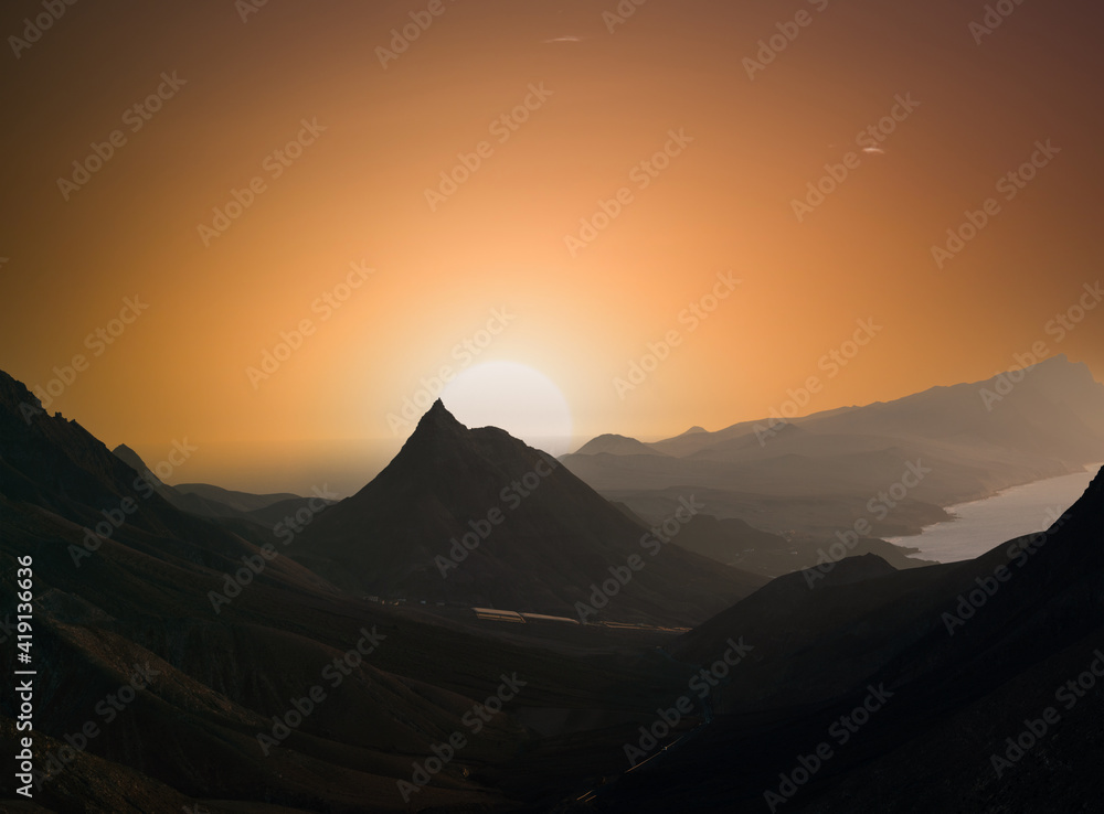 Mountain landscape with orange sky. during sunset