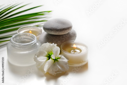 Composition with symbolic objects for spa salon. Stone therapy attributes for cosmetic procedures. Conceptual image  rocks and flowers representing balance. Close up  copy space  top view  background.