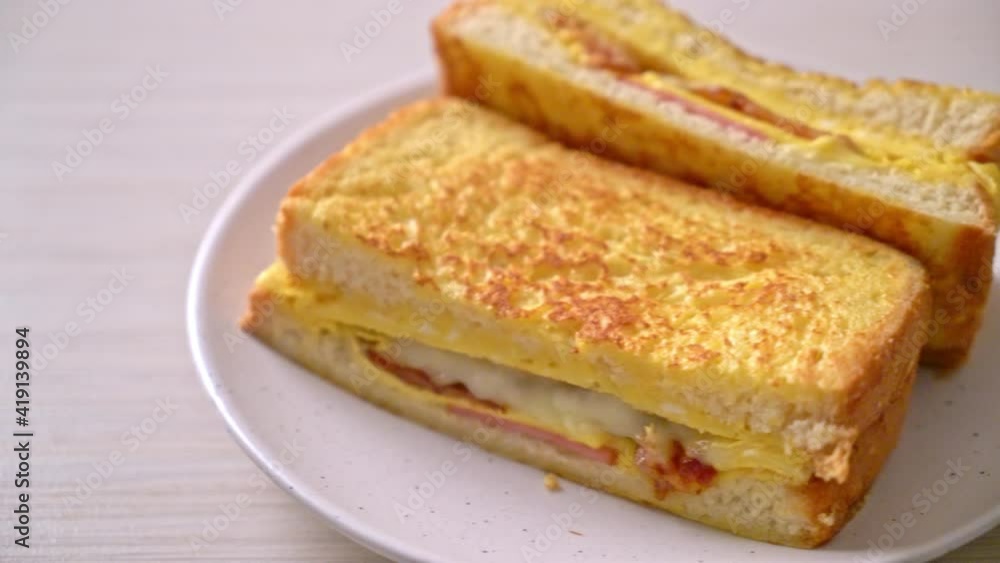 Homemade French toast ham bacon cheese sandwich with egg Homemade French toast ham bacon cheese sandwich with egg