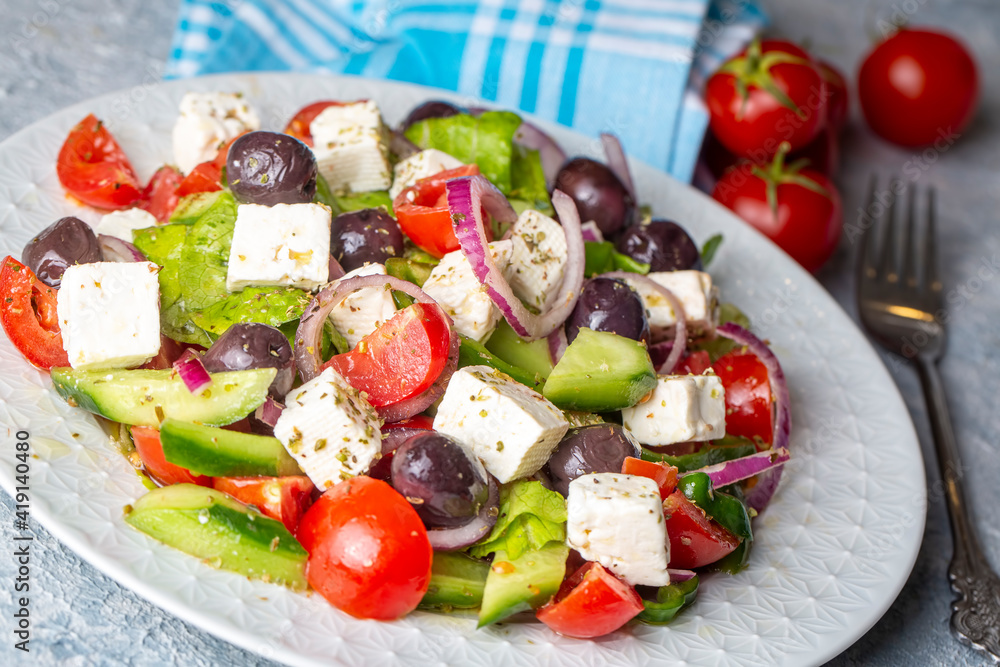 Greek salad with fresh vegetables, feta cheese and kalamata olives. Healthy food.