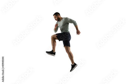 Jump. Young caucasian male model in action, motion isolated on white background with copyspace. Concept of sport, movement, energy and dynamic, healthy lifestyle. Training, practicing. Authentic.