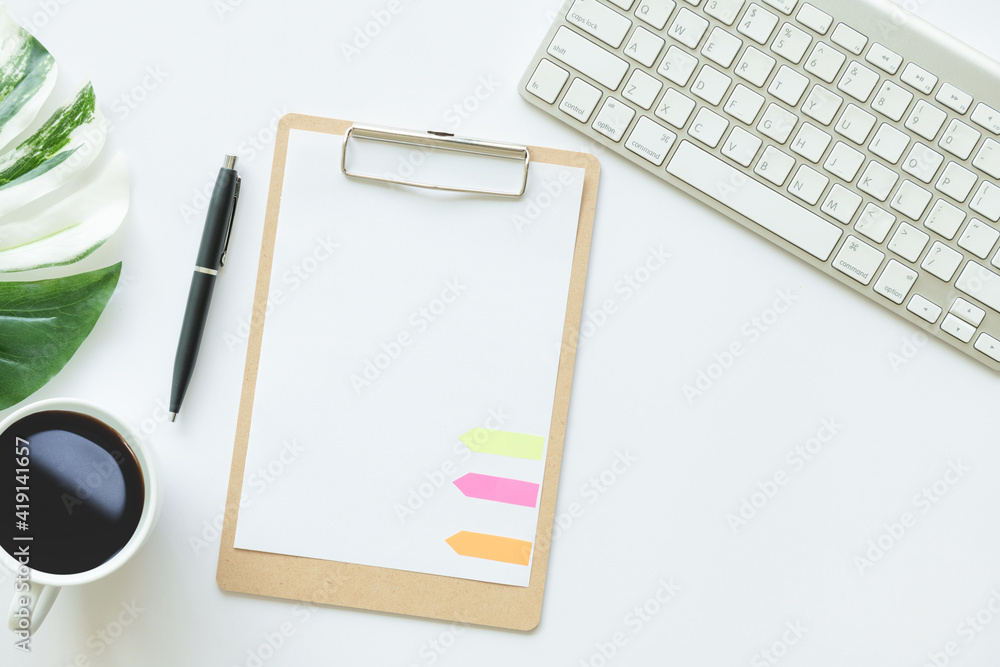 Creative flat lay photo of workspace desk. top view office desk with mockup clipboard, keyboard, coffee, pen, leaf on white background. Workspace concept. Top view, copy space, mockup, flat lay. Creative flat lay photo of workspace desk. top view office desk with mockup clipboard, keyboard, coffee, pen, leaf on white background. Workspace concept. Top view, copy space, mockup, flat lay.