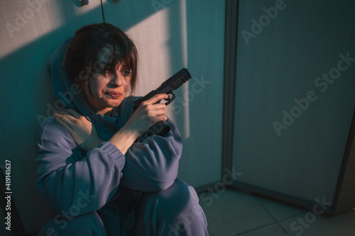 Canvastavla Depressed woman holding a gun planning suicide