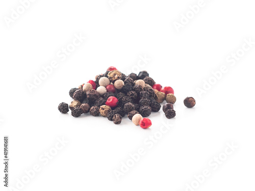 Mix of black, white, green and pink peppercorns isolated on white background
