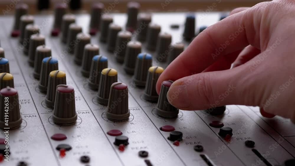 Sound Engineer, DJ Moves Sliders with Fingers on Audio Mixer in Recording Studio Sound Engineer, DJ Moves Sliders with Fingers on Audio Mixer in Recording Studio