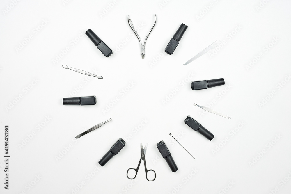 Nail artist tools set in a circle. Professional manicure tools and nail gels on white background with copy space Nail artist tools set in a circle. Professional manicure tools and nail gels on white background with copy space