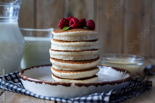 Vegetarian breakfast: rice pancakes with raspberries on a white plate