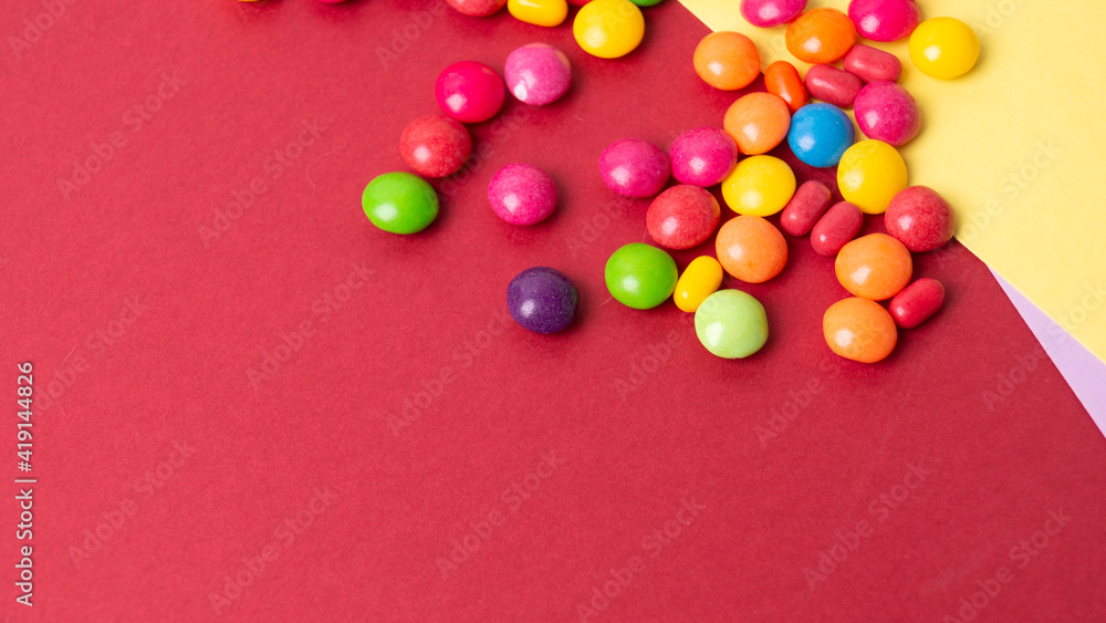 Obraz premium colorful little candies on a colored background