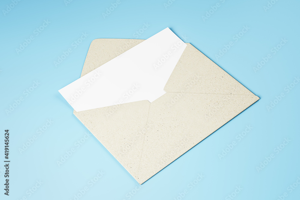 Invitation white card in kraft paper envelope with copyspace on blue backdrop. Mockup Invitation white card in kraft paper envelope with copyspace on blue backdrop. Mockup