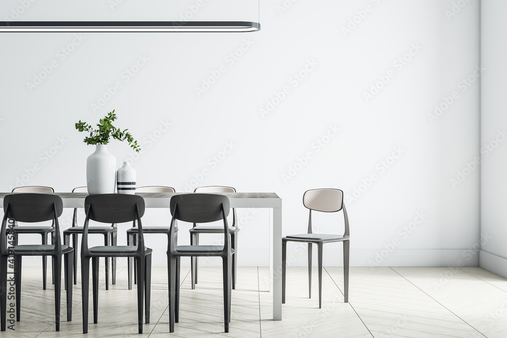 Spacious dining room with light wall, monochrome wooden furniture, parquet and white vase on big table