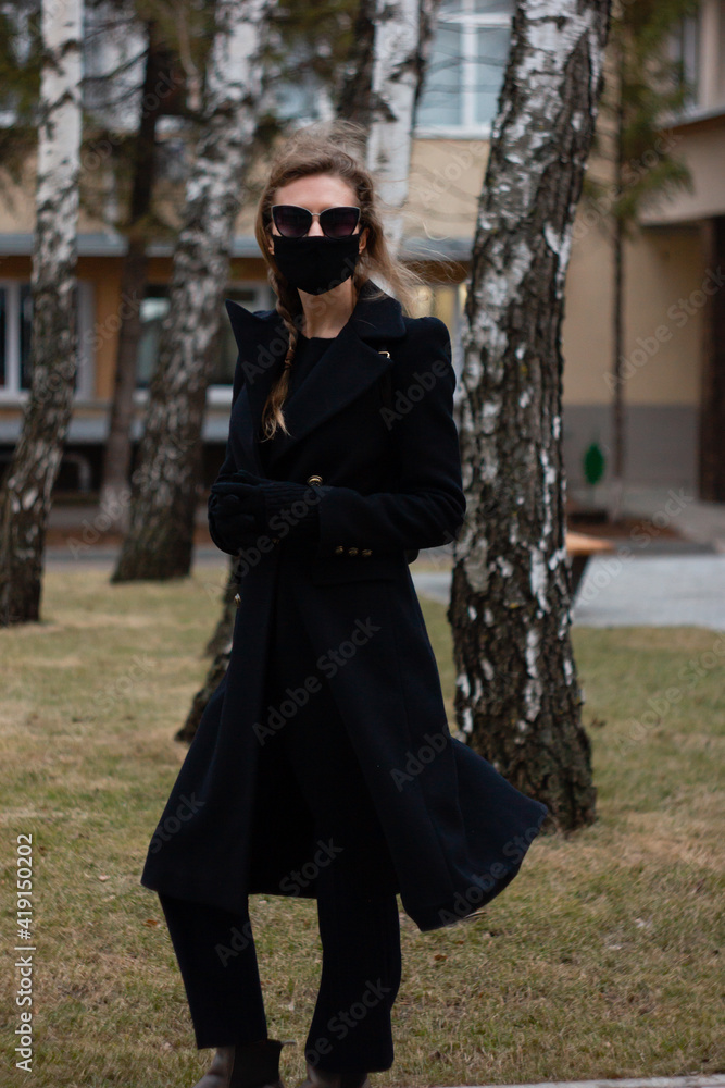 Closeup shot of a female with sunglasses and a protective mask Closeup shot of a female with sunglasses and a protective mask