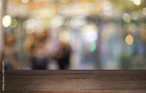 Empty wooden table in front of abstract blurred background of coffee shop . can be used for display or montage your products.Mock up for display of product