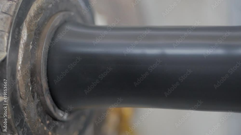 A plastic-wrapped cable moving along a conveyor belt. Cable Production Line A plastic-wrapped cable moving along a conveyor belt. Cable Production Line