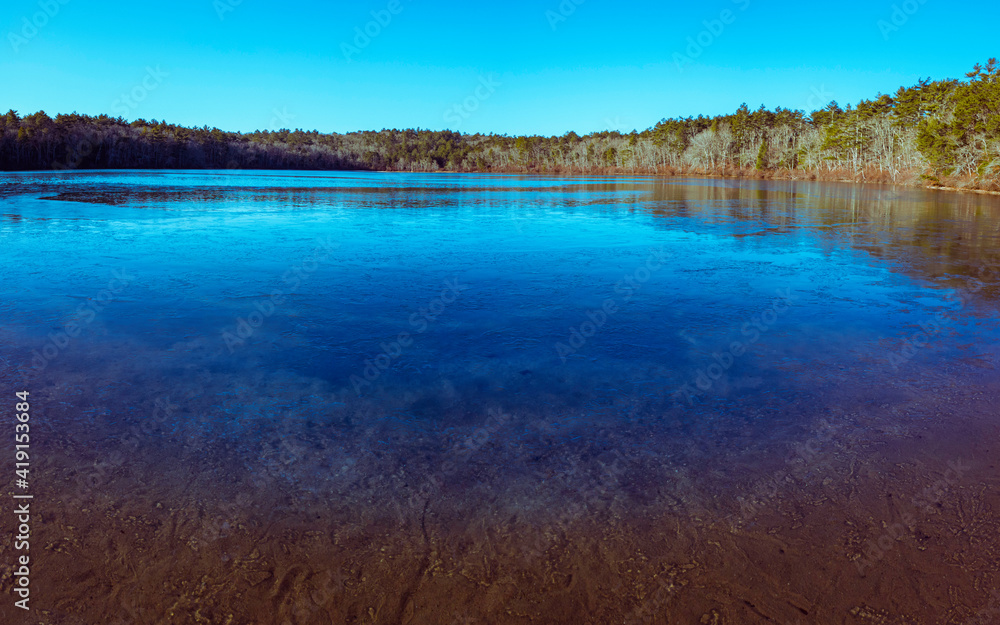 Frozen Glacial Moraine Kettle Pond in the Pine Forest at Dawn Frozen Glacial Moraine Kettle Pond in the Pine Forest at Dawn