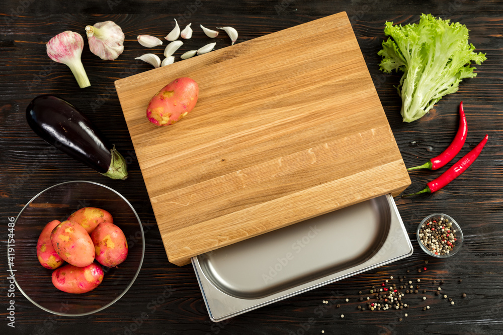 Fresh vegetables, herbs and spices on a cutting board
