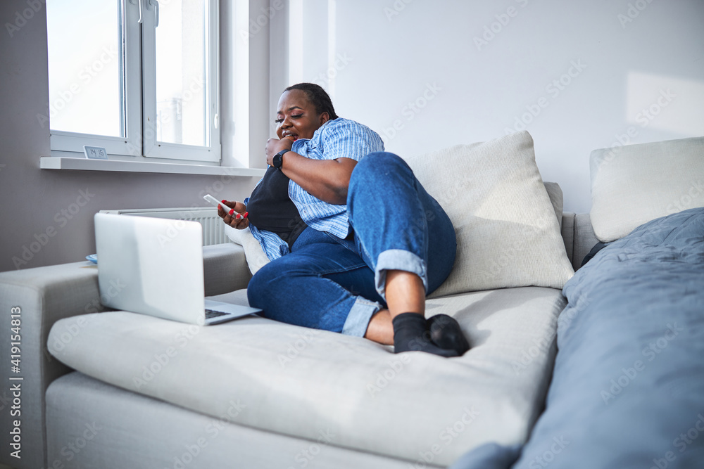 Tranquil African American woman enjoying her rest on sofa