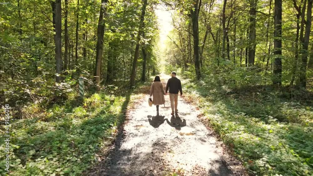 couple walking by autumn forest couple walking by autumn forest