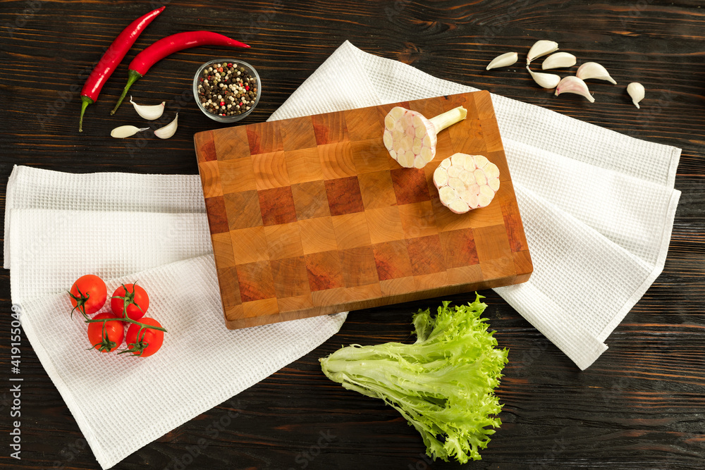 Fresh vegetables, herbs and spices on a cutting board