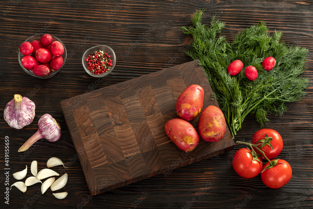 Fresh vegetables, herbs and spices on a cutting board