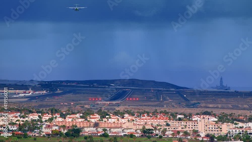 Airplane runway in Bad Weather.
a Passenger Plane descends for Landing.
Airport on the island of Tenerife, Spain.
 photo