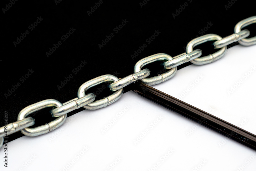 Fototapeta premium an iron chain divides the plane in half into black and white parts on the white part lies a fountain pen the concept of freedom of speech