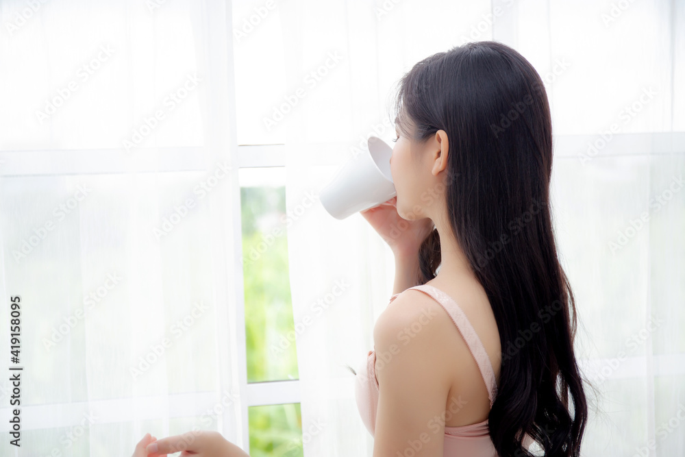 Beautiful young asian sexy woman in underwear drinking coffee near windows in the morning, girl with seductive figure fit drinking beverage for relax and resting after wake up, lifestyle concept. Beautiful young asian sexy woman in underwear drinking coffee near windows in the morning, girl with seductive figure fit drinking beverage for relax and resting after wake up, lifestyle concept.