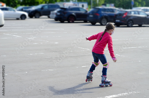 Teenage girl rollerblading in the parking lot. Blurred focus, copying text