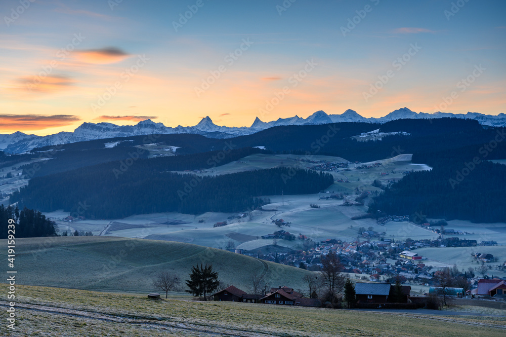village of Zäziwil at sunset with hills of Emmental and Bernese Alps