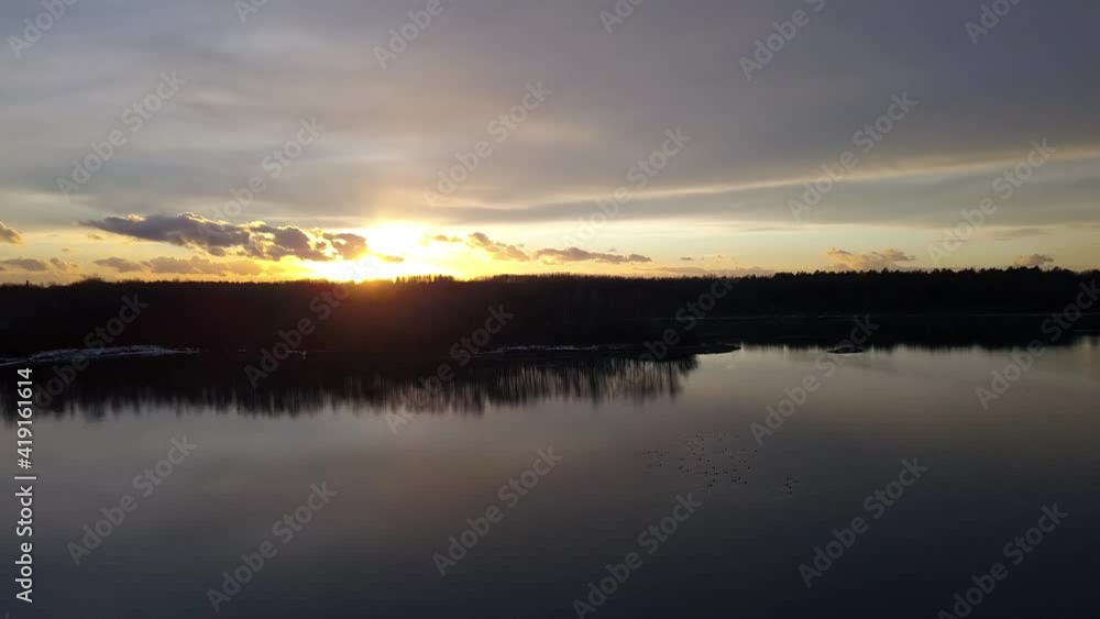 Hovering over a large and big lake at sunset. High quality 4k footage Hovering over a large and big lake at sunset. High quality 4k footage
