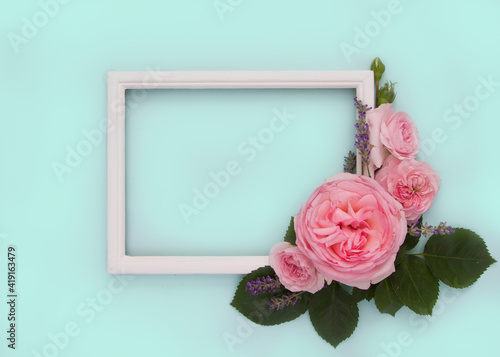 Layout with white wooden frame and pink rose flowers on light green background, empty space for text.Mock up for Wedding, Mother's day, Women's day, 8 march, Valentine's day, Birthday.