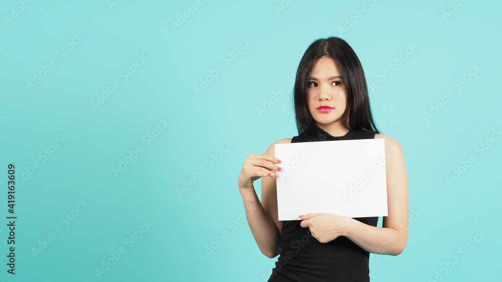 Blank empty paper in teenage girl or woman's hand on green or Tiffany Blue background.she wear black dress Blank empty paper in teenage girl or woman's hand on green or Tiffany Blue background.she wear black dress