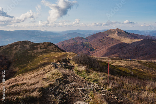 Fototapeta Naklejka Na Ścianę i Meble -  Autumn in the Bieszczady Mountains Poland. Trekking trail, blue sky.