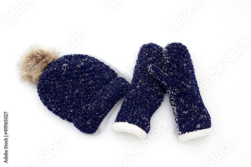 dark blue knit mittens and hat in white snow