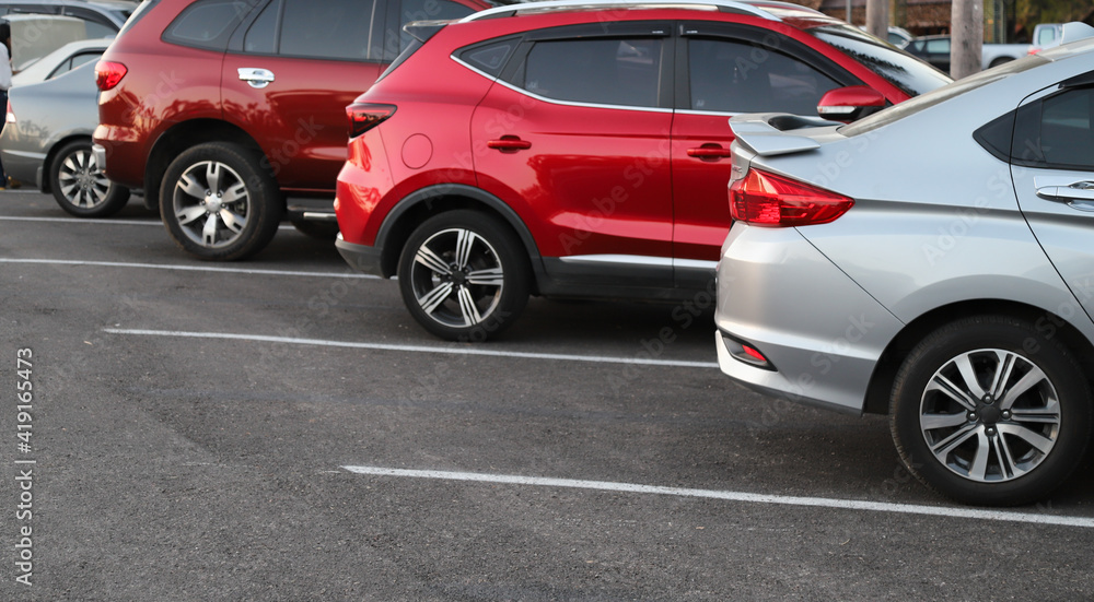 Closeup of rear, back side of blue car with other cars parking in outdoor parking area. Closeup of rear, back side of blue car with other cars parking in outdoor parking area.